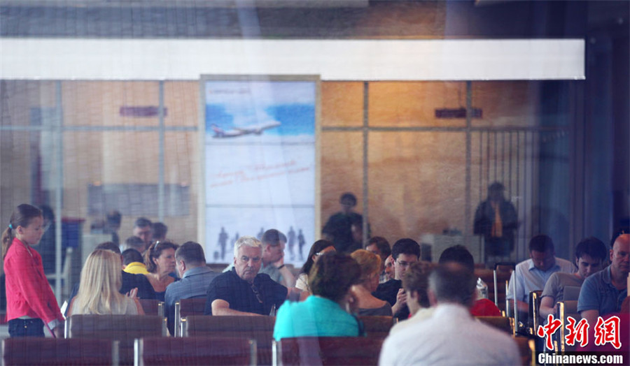 7月11日，莫斯科谢列梅捷沃机场国际航班起落照常，图为D航站楼“过境区”内国际航班乘客正在等候登机。中新社发 贾靖峰 摄