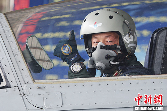 前舱飞行员郝云涛向机务人员示意”可以起飞“。图片：中新社发 孟庆宝摄